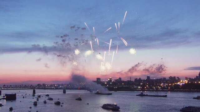  Fireworks explosions over the river in the summer evening city.