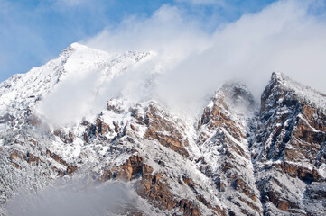 Rocky hillside with scattered trees and snow