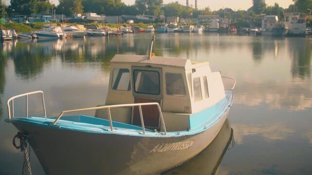 The boat is moored on the river bank in summer.