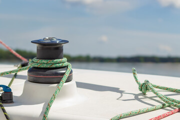 Reel and rope for sail control on a sailing yacht. Blocks, ropes, and winches for raising the sail. Vacation in marine travel