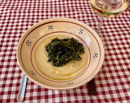 Close up of fave e cicoria - cream broad beans puree with bitter chicory - a typical Puglian dish.