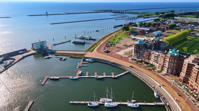 Spectacular coast of Lelystad,the Netherlands. Amazing marina with several boats and beautiful cityscape. Aerial view.