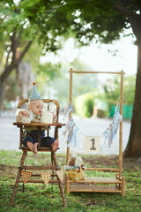 Boy crash his first smash cake in the park
