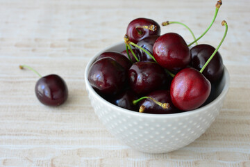 a cute gray Bowl of fresh ripe cherries