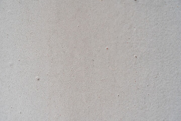Close-up of a textured gray concrete wall, showcasing its subtle variations.