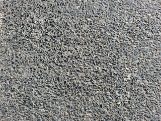 Textured Surface of Rough Stone with Random Patterns and Natural Dark Shades