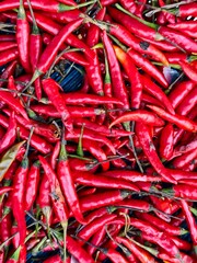 Vibrant Red Chili Peppers Displayed in Abundant Arrangement on Market Table