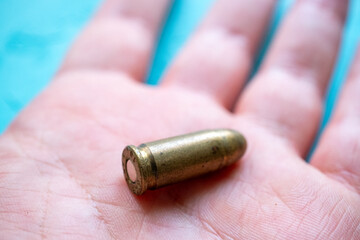 hand holding a bullet close up