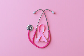 Pink ribbon and stethoscope on pink background for cancer awareness