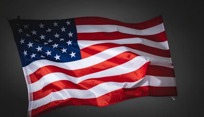 Fototapeta premium Dramatic close-up of a waving American flag against a dark gray background. Perfect for patriotic themes, Independence Day, or political concepts.