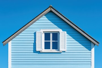 Charming Blue House with White Window Under Clear Blue Sky