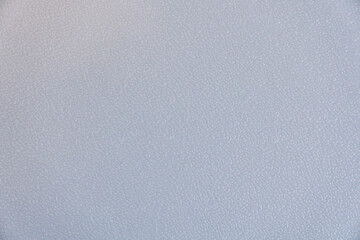 A grey background with a few white dots