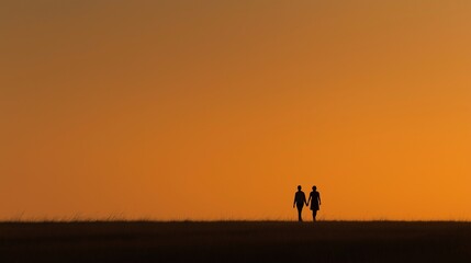 Silhouette couple holding hands walking across horizon during sunset, warm tone, peaceful and romantic scene. 
