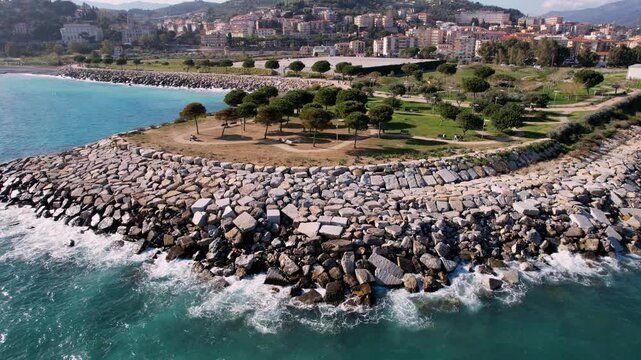 Experience vibrant allure of Imperia, Italy, through drone footage featuring charming city, green park, and stunning coastline. Ideal for showcasing harmonious blend of urban and natural beauty.