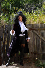 Young female musketeer with a saber in her hands