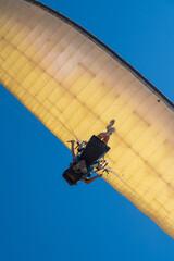 Paraglider Flying Against Clear Blue Sky, View from Below