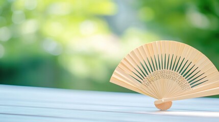 fan Hand fan with intricate patterns being used to create a summer breeze.
