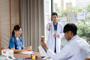 Fototapeta premium Team discussion: Doctor instructing healthcare professionals during meeting
