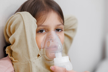 child is sick in bed. inhalation at home. Mom gives medicine to her daughter. Concept disease,...