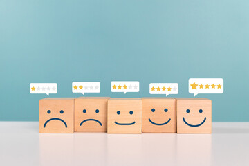 Satisfaction, service rating and positive feedback concept. Wooden cube with rating feedback...