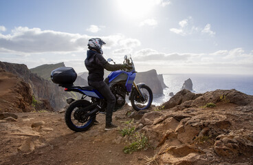 Enduro Motorcycle with Driver Posing on Sea Cliff , Madeira island