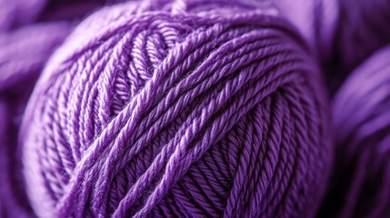 Close-up of vibrant purple yarn ball with detailed texture for knitting and crafting