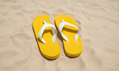 Naklejka premium Bright yellow flip flops on sandy beach or poolside