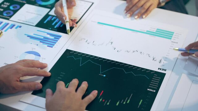 Business team analyzing financial data and discussing growth opportunities during a productive meeting
