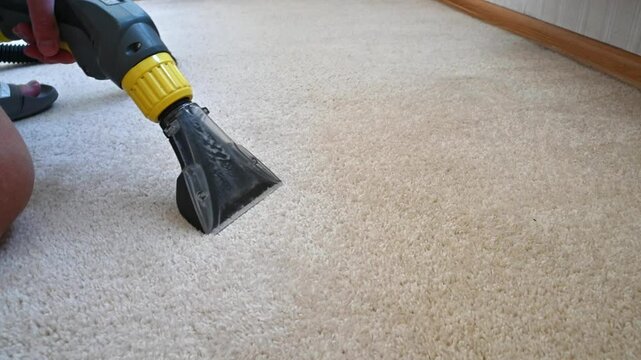 Deep carpet cleaning with vacuum extraction removes stubborn dirt from light beige floor