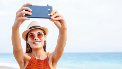woman using smart phone at the beach
