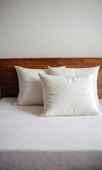 A simple bed with two white pillows