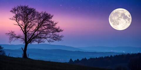 A full moon casts its light across the dark, cloudy night sky over the silhouette of the mountains