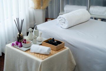 Exquisite display of beauty treatment and spa salon accessories arranged on spa table in luxury spa resort. Relaxing spa massage and recreation background concept. Quiescent
