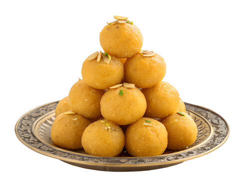 Stacked indian besan laddu sweets garnished with almonds on decorative plate