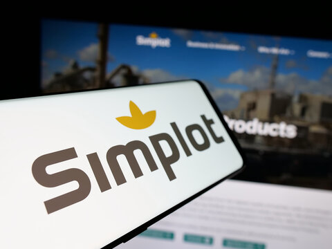 Stuttgart, Germany - 04-26-2025: Smartphone with logo of US agribusiness J. R. Simplot Company on screen in front of website. Focus on center-left of phone display.