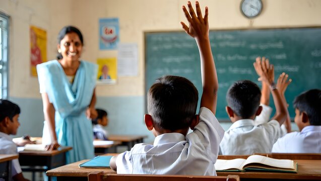 A smiling teacher in a classroom with students raising hands to participate in the lesson.
