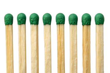 Row of matchsticks with green tips on a dark black background