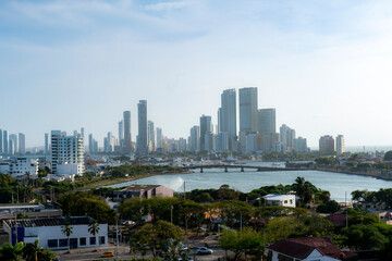 Fototapeta premium Afternoon photo of Cartagena, Colombia showing the modern skyline with tall buildings, the bay, and surrounding neighborhoods under soft light.