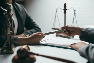 Business people exchanging money near justice scale and gavel, concept of corruption and bribery