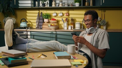 African American smiling guy ethnic male freelancer student relax studying break playing online...