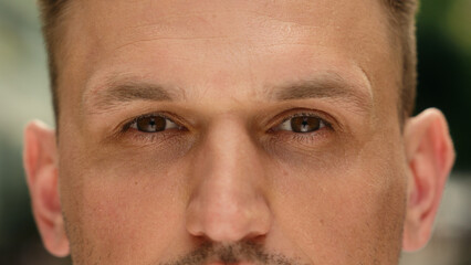 Eyes close up dark iris human eye open Caucasian man cropped view eyesight guy outdoors clear...