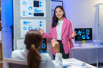 Young manager explaining company strategy during a business meeting, presenting charts and graphs to illustrate key data and insights