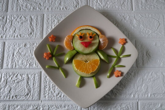 Creating Fun Fruit Art Person on Plate with Apple and Orange