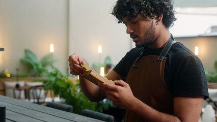 Indian Arabian latino man sad disappointed guy waiter cafe worker in apron male business owner...