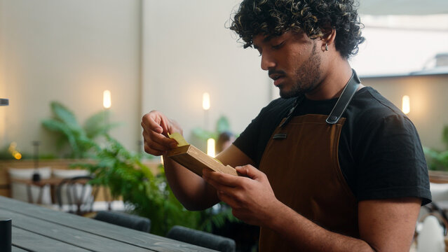 Indian Arabian latino man sad disappointed guy waiter cafe worker in apron male business owner barista work in cafe service no money cash tips bill payment serving in restaurant dissatisfied bankrupt