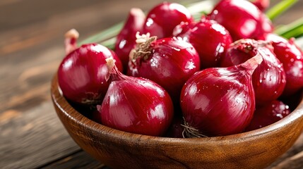 A delightful assortment of fresh red shallots arranged in a wooden bowl, showcasing their charming shape and vibrant color, ideal for gourmet cooking and flavor enhancement.