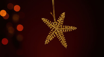 Golden Snowflake Christmas Ornament with Bokeh Lights on Dark Background