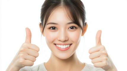 Smiling Asian woman enthusiastically with gives a thumbs up, signaling approval or like on a white background,