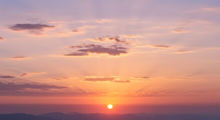 The sun sets over the horizon, painting the sky with fiery oranges and soft pinks.