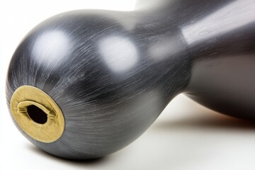 Obraz premium Elegant gourd art piece in dark gray with golden accent on white background showcasing smooth texture and natural shape in studio lighting for stock photography